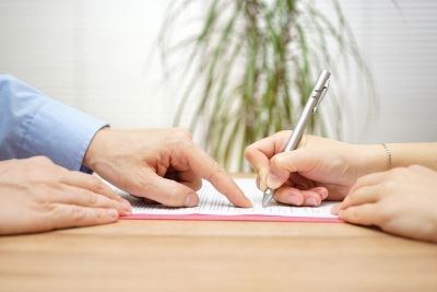 Woman Signing a Document